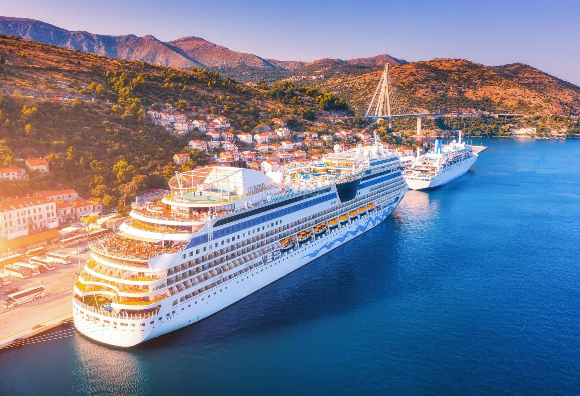 Aerial view of beautiful large white cruise ships at sunset